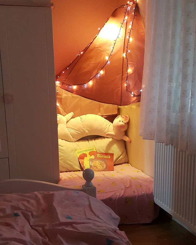 Fairy lights and cushions in a cupboard
