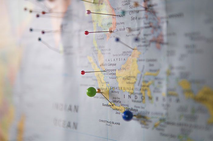 World map with pins in it