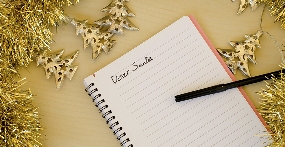 An photo of a notepad with Dear Santa written on it