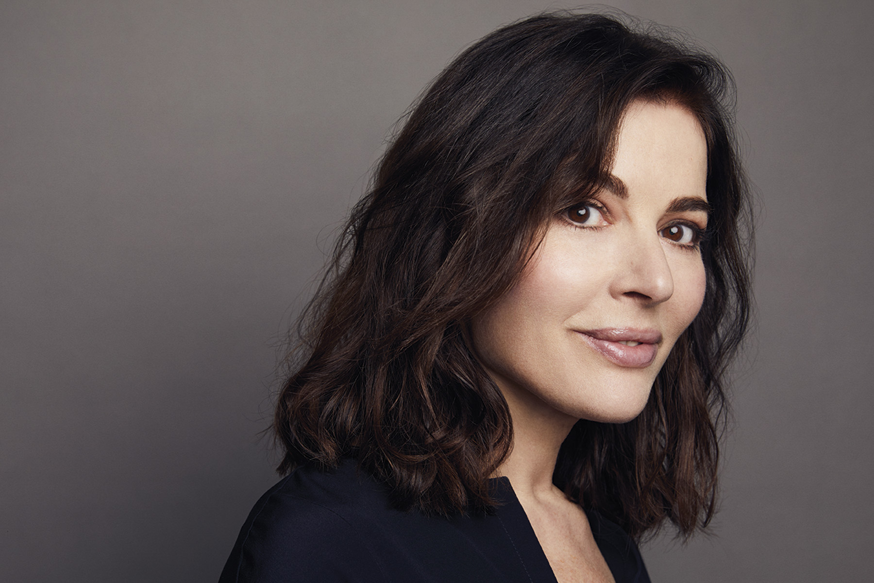 Head and shoulders photo of Nigella Lawson, wearing a black top and looking at the camera.