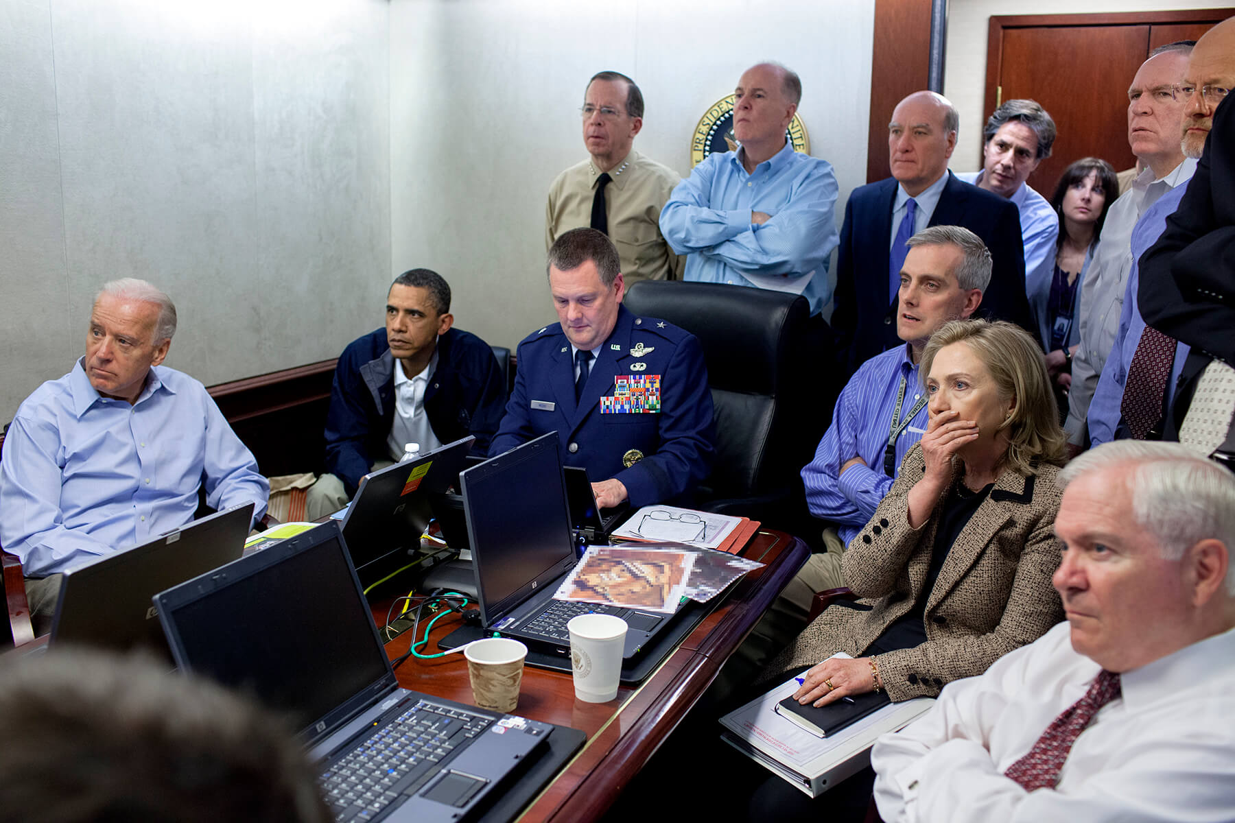 President Barack Obama and Vice President Joe Biden, along with members of the national security team, receive an update on the mission against Osama bin Laden in the Situation Room of the White House, May 1, 2011. Seated, from left: Brigadier General Marshall B. Webb, assistant commanding general, JSOC; Deputy National Security Advisor Denis McDonough; Secretary of State Hillary Rodham Clinton; and Secretary of Defense Robert Gates. Standing, from left: Admiral Mike Mullen, chairman of the Joint Chiefs; National Security Advisor Tom Donilon; Chief of Staff Bill Daley; Tony Blinken, national security advisor to the vice president; Audrey Tomason, director for counterterrorism; John Brennan, assistant to the president for homeland security and counterterrorism; and Director of National Intelligence James Clapper (out of frame). 