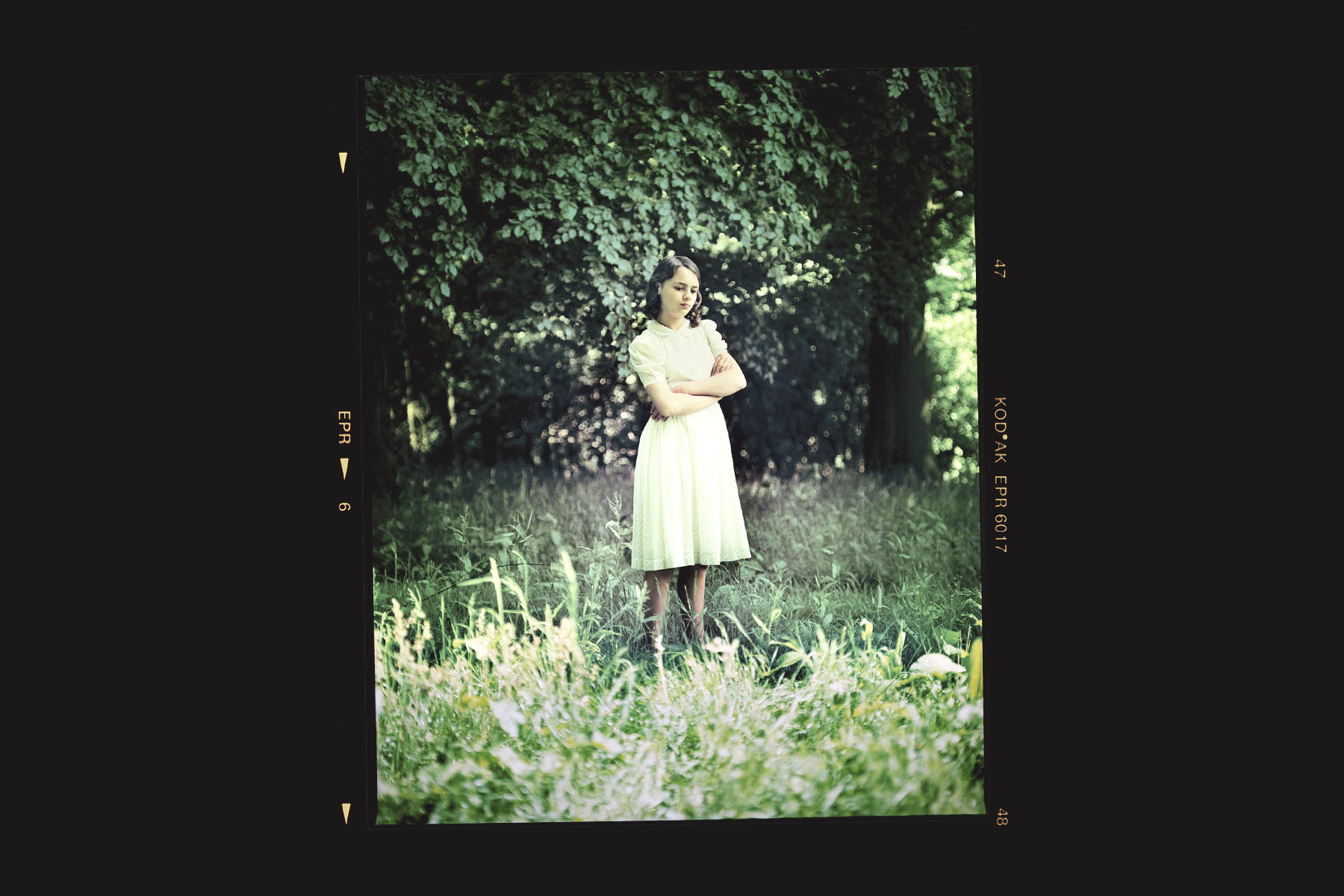 A photograph of the model posing as Bryony standing in a field