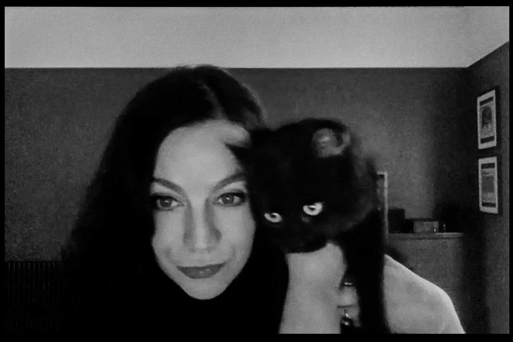 A black-and-white photograph of Jenni Fagan holding a black cat
