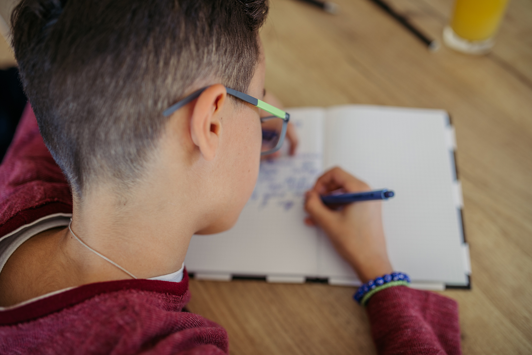 Image of a young boy writing into a diary