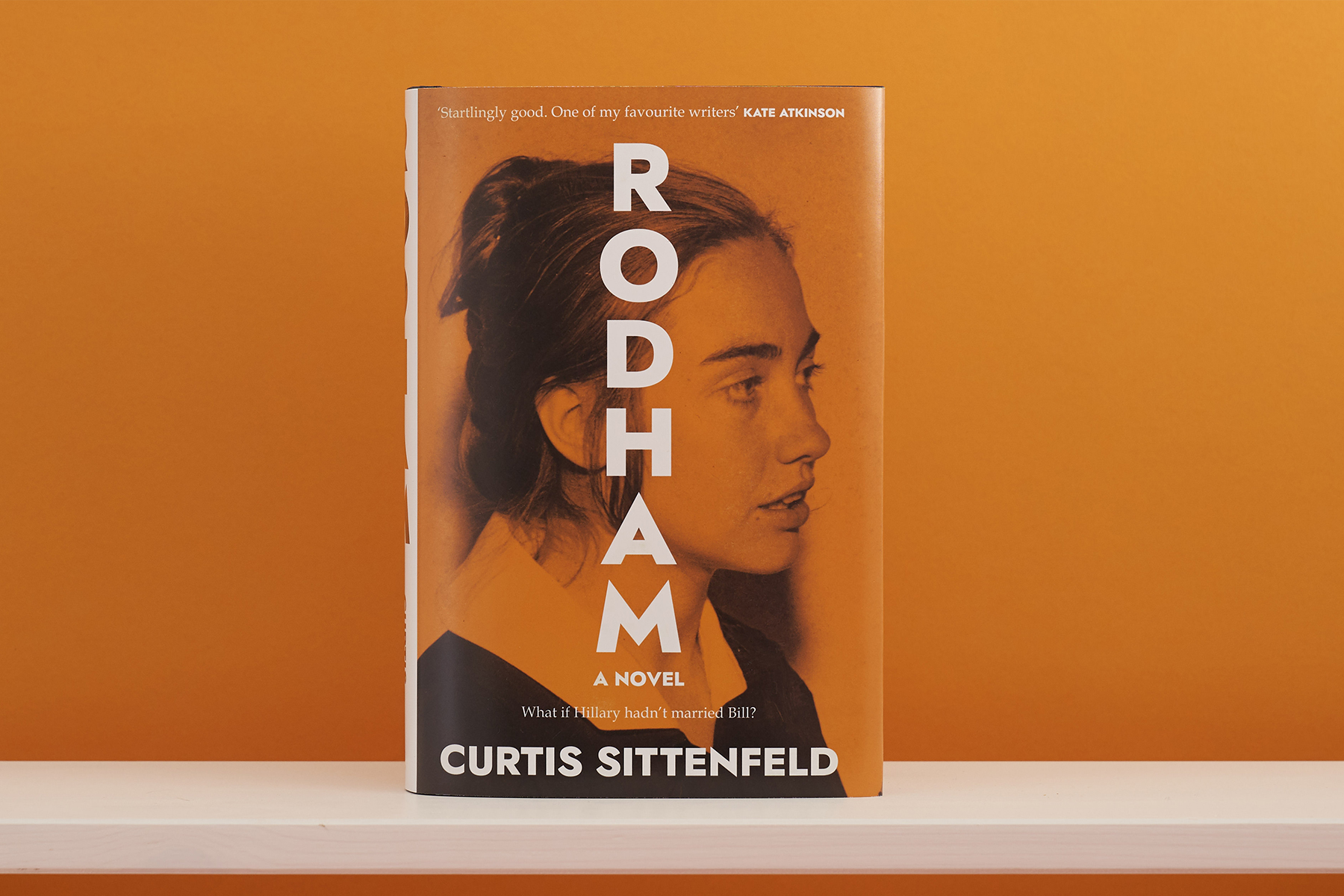 An image of Curtis Sittenfeld's book 'Rodham' on an orange background