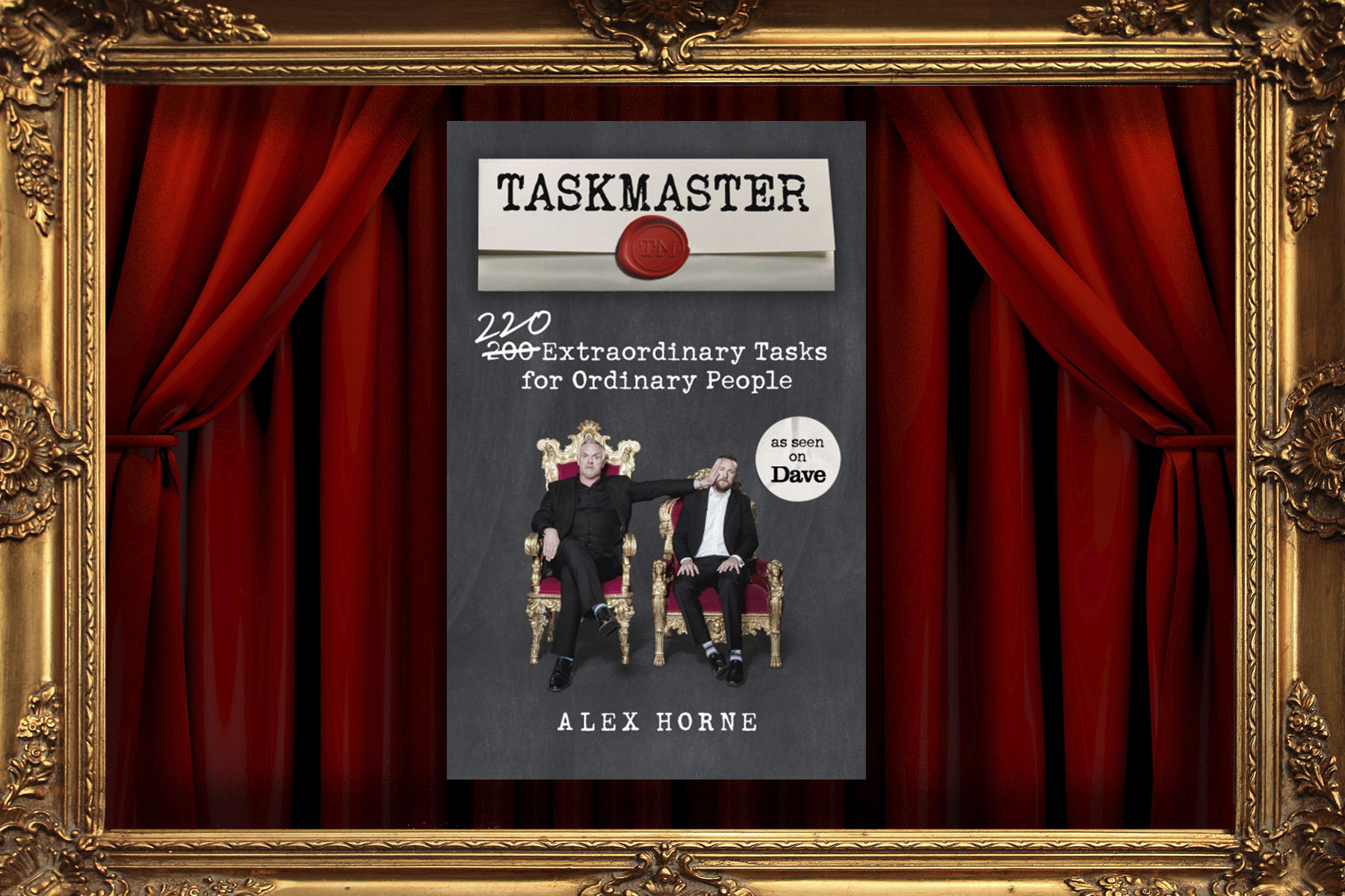 The Taskmaster book, in front of the trademark curtains of the television show.