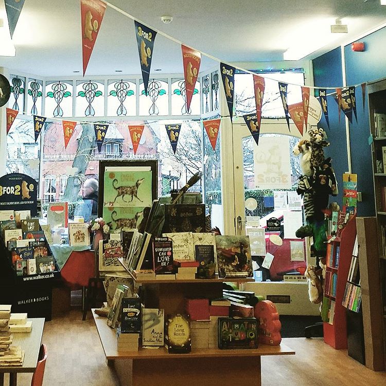 A photo of the inside of the bookshop Storytellers Inc. There are books and bunting everywhere