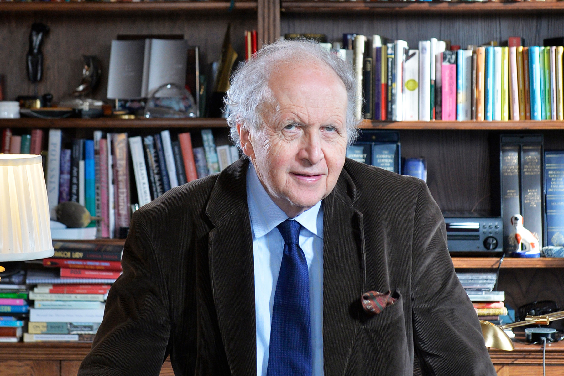 A photograph of Alexander McCall Smith in front of a bookshelf