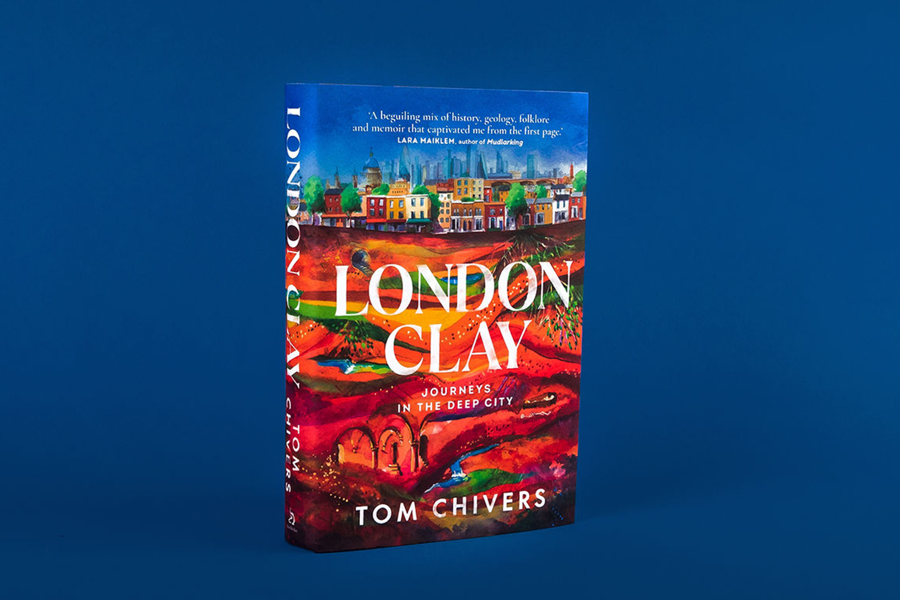 The book London Clay by Tom Chivers, photographed against a blue background.