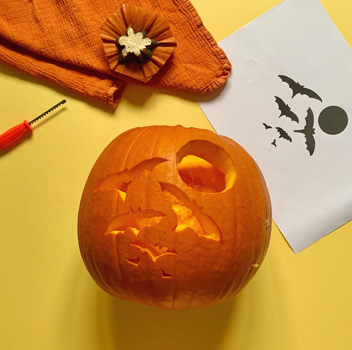 A photo of a pumpkin with the stencil carved into it