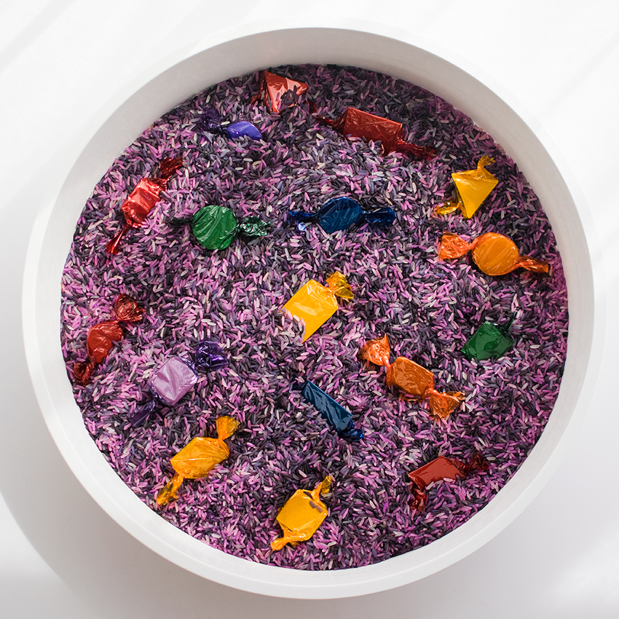 A photo of the final result which includes the bowl filled with purple rice and the cardboard sweets