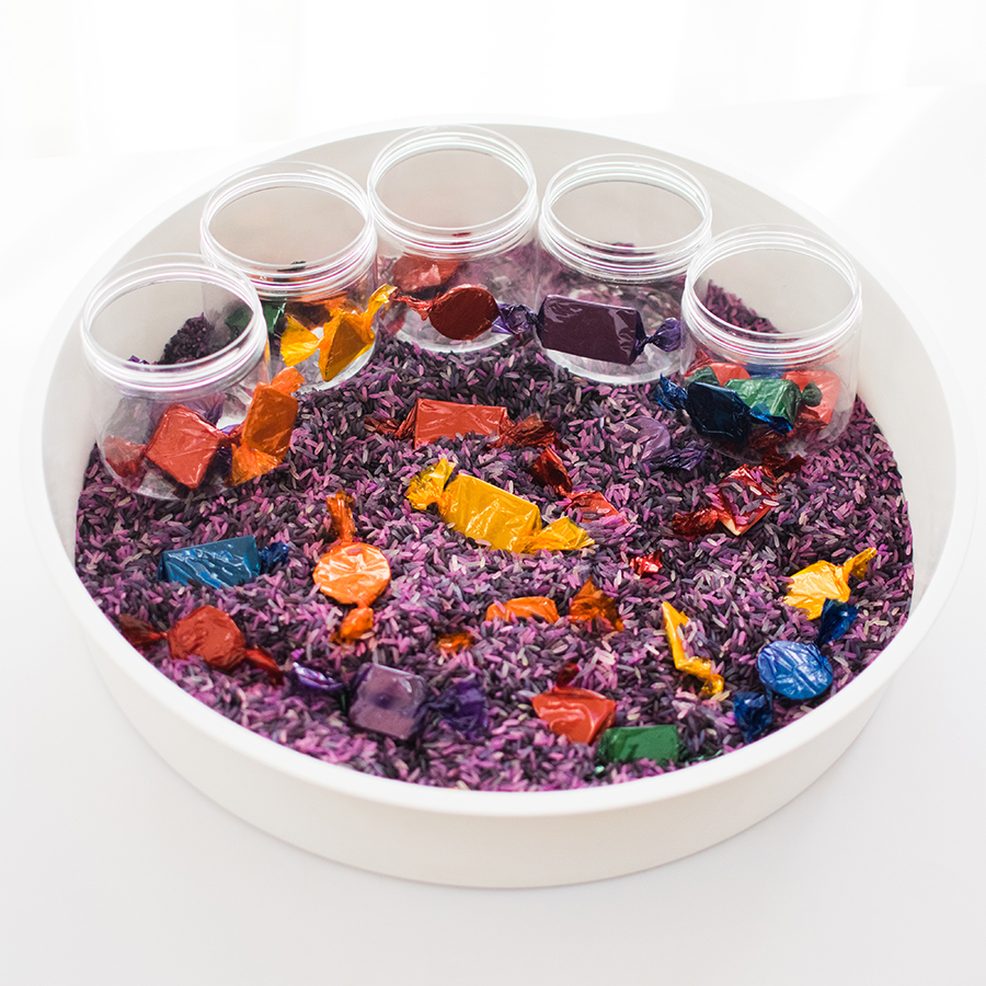 A photo of the final result which includes the bowl filled with purple rice, the cardboard sweets and the cardboard sweets in jars