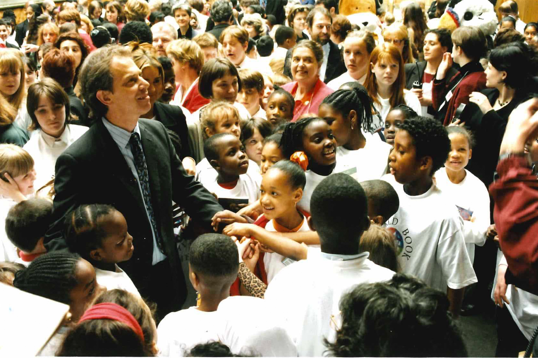A photograph from 1997 of Tony Blair at the Globe Theatre surrounded by children