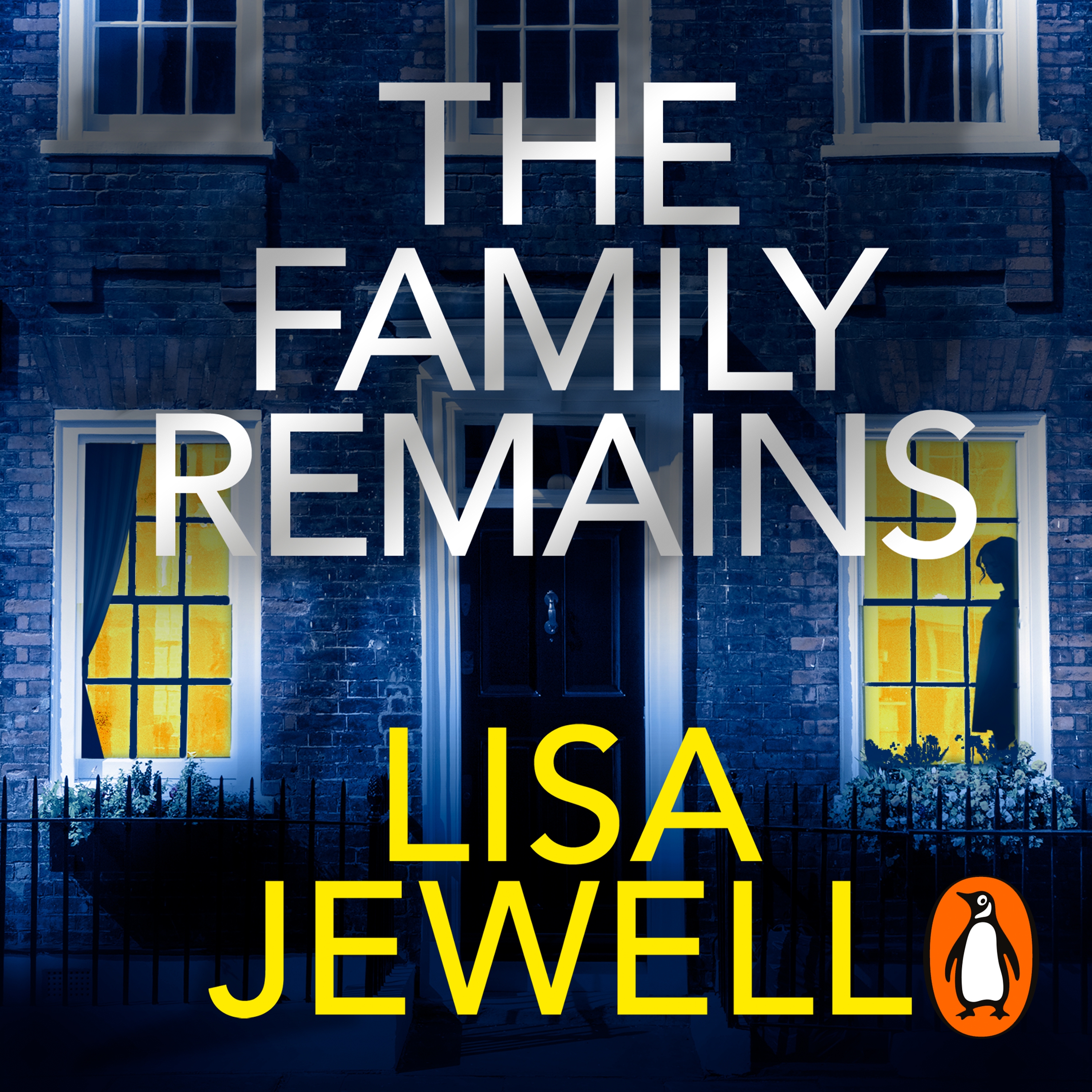 Cover of The Family Remains by Lisa Jewell. The front of a house, with the door in the middle and windows on each side. A silhouette appears on the right window. The title is in large white letters at the centre of the image, and the author's name in yellow at the bottom.