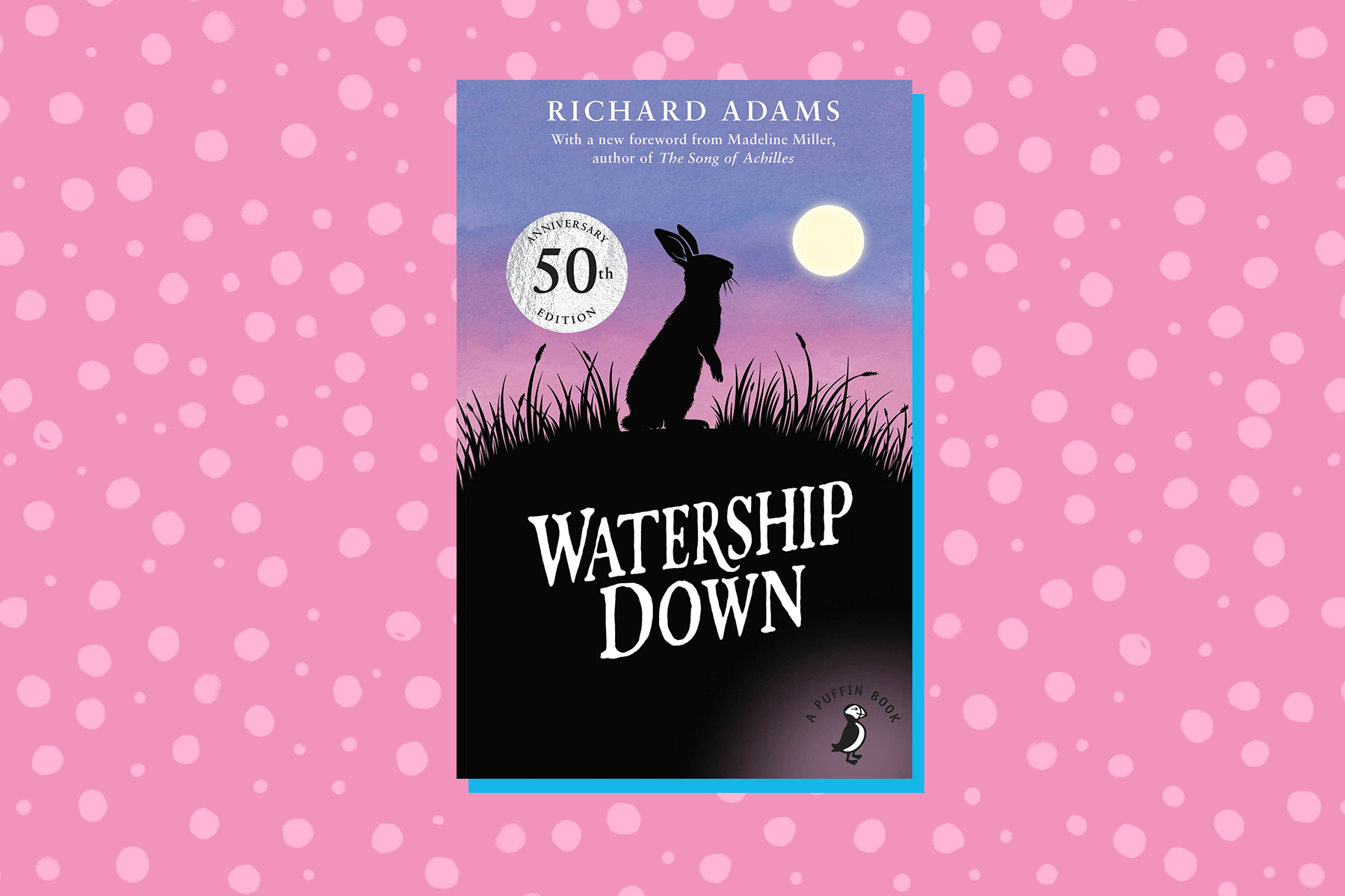 An image of the 50th anniversary front cover of Watership Down on a pink spotted background