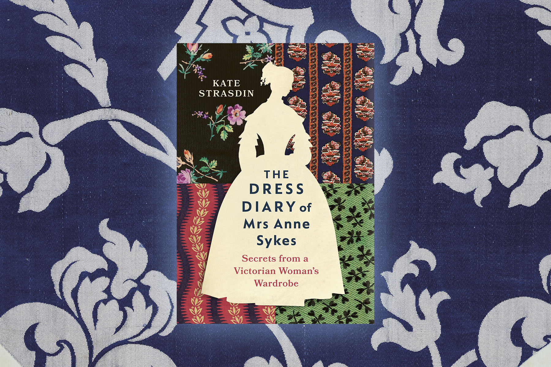 Book, The Dress Diary of Mrs Anne Sykes, against a blue and white fabric backdrop.