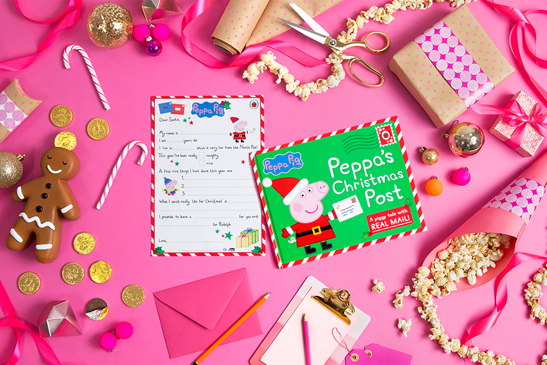 A photo of the Peppa Pig latter template on a pink background surrounded by Christmas decorations