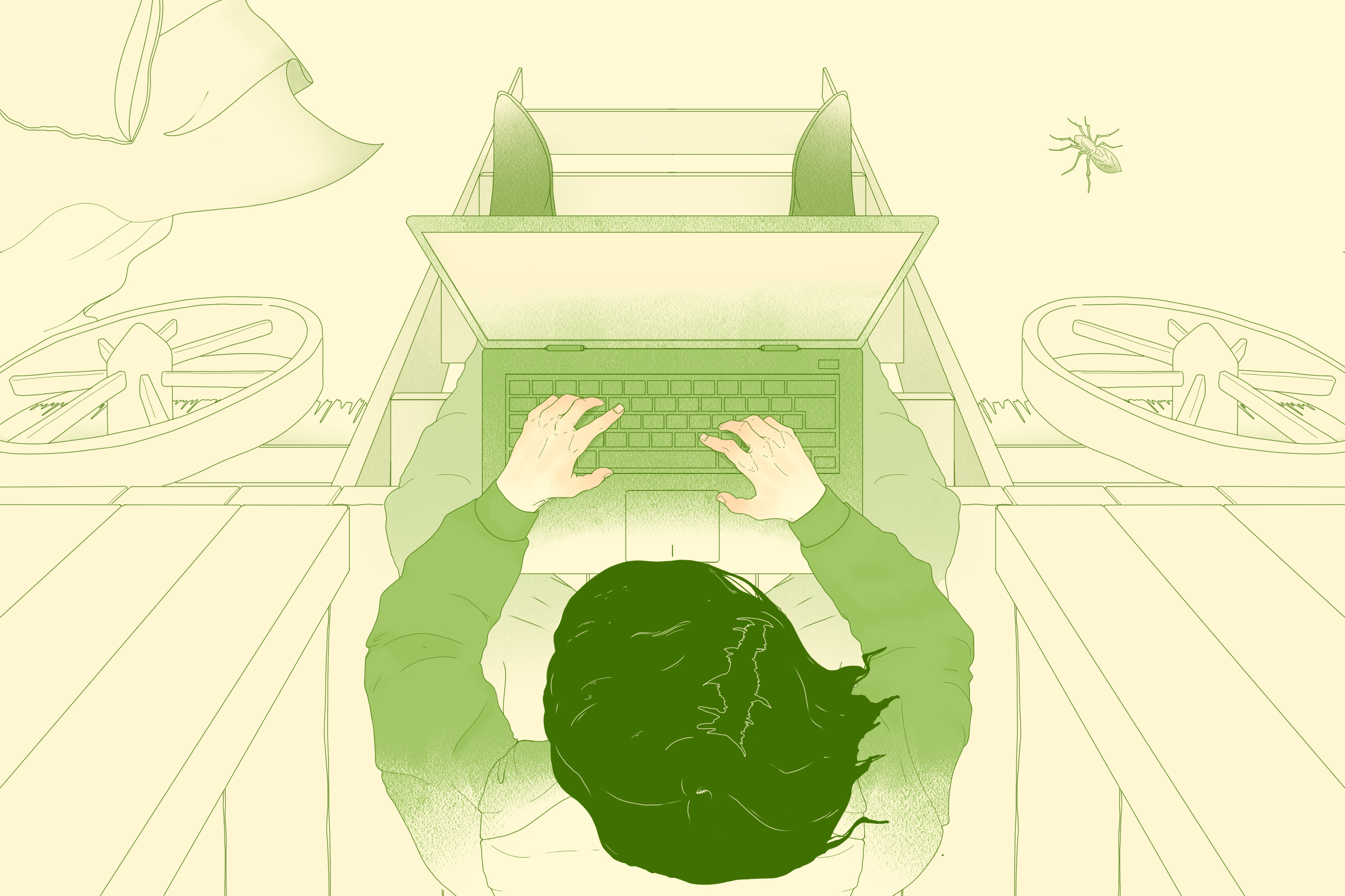 A person viewed from above; they are writing on a laptop while sitting on the steps of a shepherd's hut