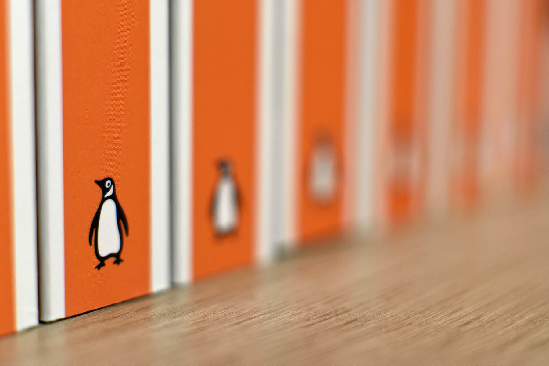 An image of orange Penguin book spines in a row