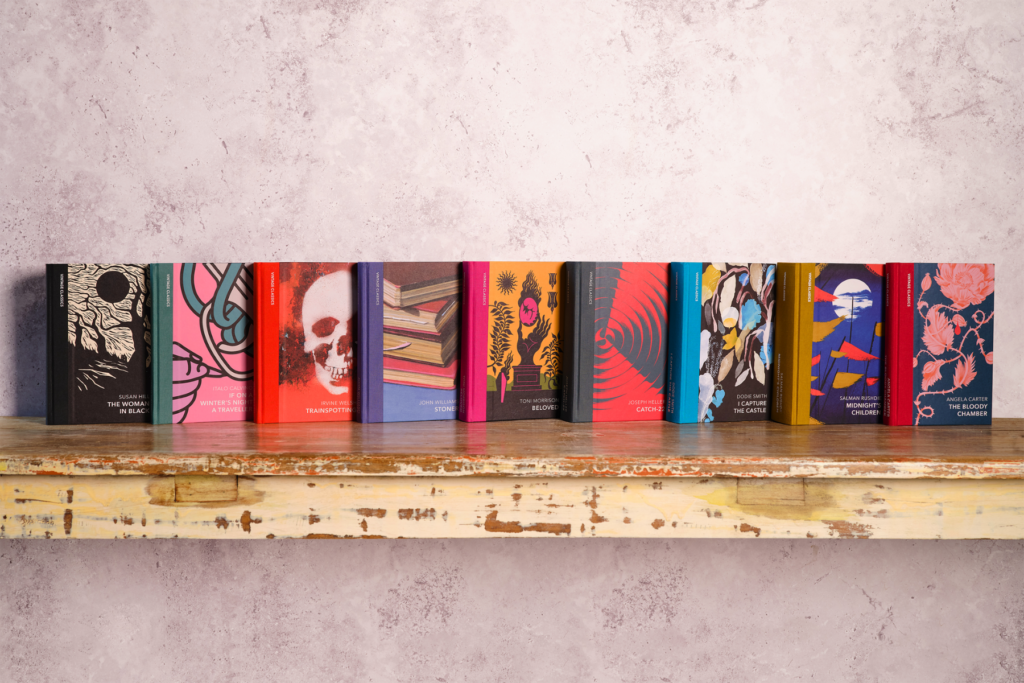 9 hardback bound books on a wooden shelf