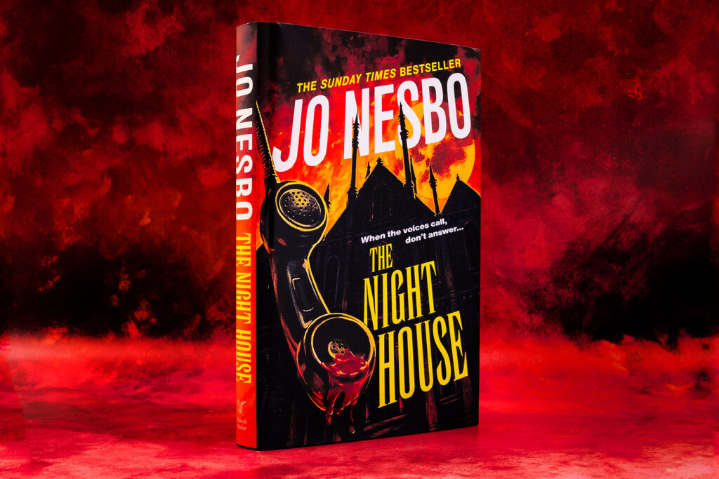 Photograph of book, The Night House by Jo Nesbo, against a vivid red and black background