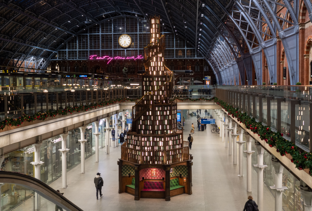 Photo of this year's St Pancras International tree - a 12-foot-tall staircase of hand-painted books